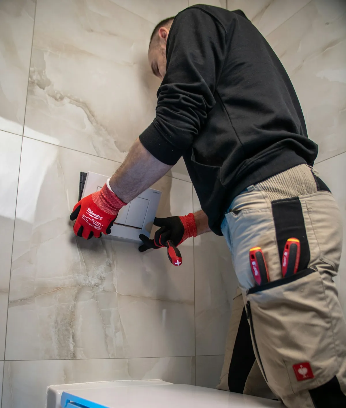 Shoreline technician installing a bathroom fixture on marble tile